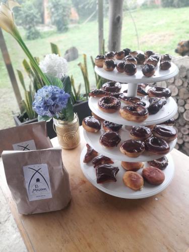 a three tiered display of donuts on a table at Glamping El Mirador de las estrellas in Bojacá