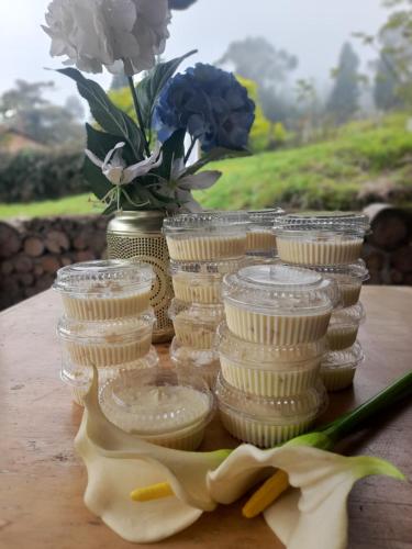 a group of glass jars sitting on a table with flowers at Glamping El Mirador de las estrellas in Bojacá