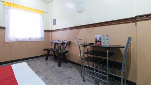 a room with two chairs and a table and a window at RedDoorz Plus near Municipality of Luisiana Laguna in Laguna