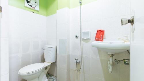 a bathroom with a toilet and a sink at RedDoorz Plus near Municipality of Luisiana Laguna in Laguna