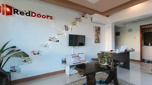 a white room with a red door sign on a wall at RedDoorz Plus near Municipality of Luisiana Laguna in Laguna