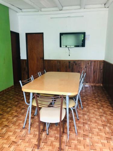 a conference room with a table and chairs and a tv at MI RIO in Colón