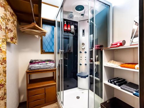 a walk in shower in a bathroom with a shower stall at Maguro House in Osaka
