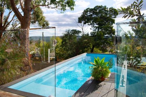 a swimming pool in a house at Cornish Hill House - stunning views with pool in Daylesford