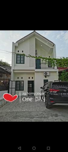 a car parked in front of a house at ZG Homy Jogja in Gondowulung