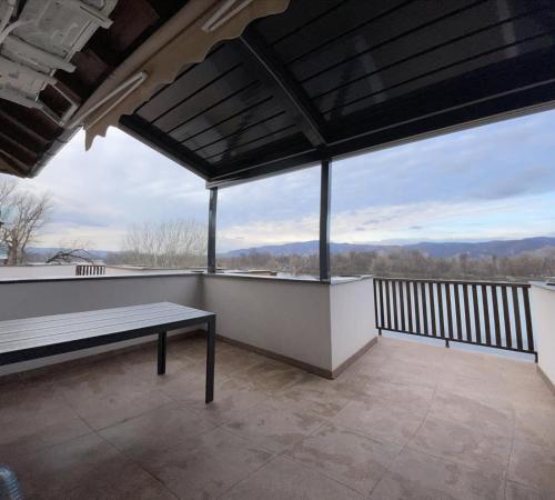 a balcony with a bench and a view of the mountains at Apartman Plaža Lux in Veliko Gradište
