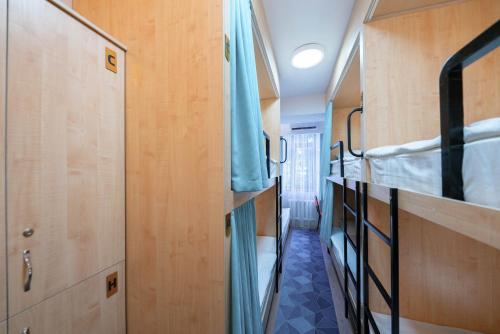 a small room with two bunk beds in it at Kaganat Hostel in Bishkek