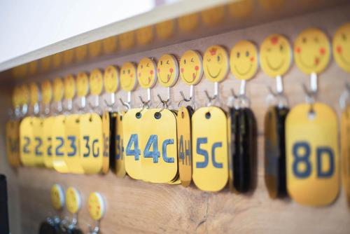 a row of yellow and black clocks on a wall at Kaganat Hostel in Bishkek