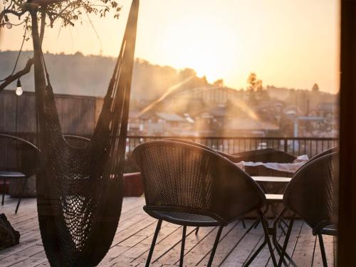 a group of chairs sitting on a patio at Kameyama Onsen Hotel in Kimitsu