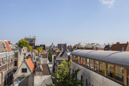 a view of a city with a train at Kuwadro Guesthouse Centrum in Amsterdam