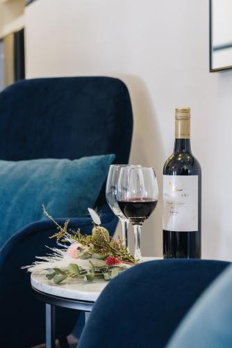 a bottle of wine and a glass on a table at Royal Hotel Wyong in Wyong