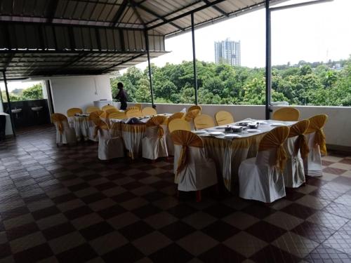 a row of tables and chairs in a room at Shamrock Inn in Cochin