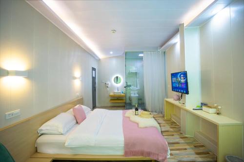 a bedroom with a large bed and a television at Sure I Do全景山宿 in Yangshuo