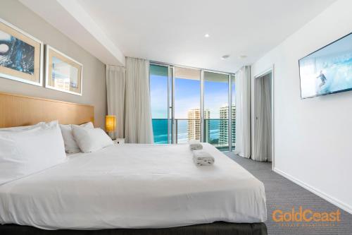 a hotel room with two beds and a large window at Gold Coast Private Apartments - H Residences, Surfers Paradise in Gold Coast