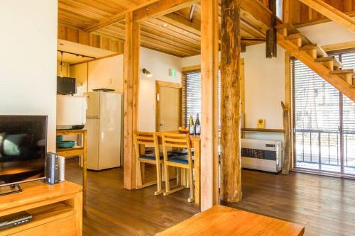 a large room with a kitchen and a living room at Misorano Chalet in Hakuba