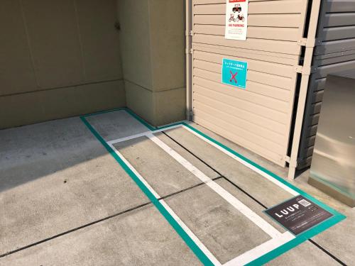a room with a door with a sign on it at Henn na Hotel Premier Kyoto Gojo Karasuma -Formerly Watermark Hotel Kyoto- in Kyoto