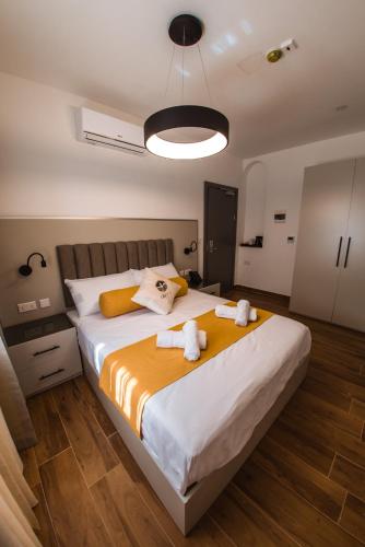 a bedroom with a large bed with towels on it at City Stay B&B in Taʼ l-Imgħajjen
