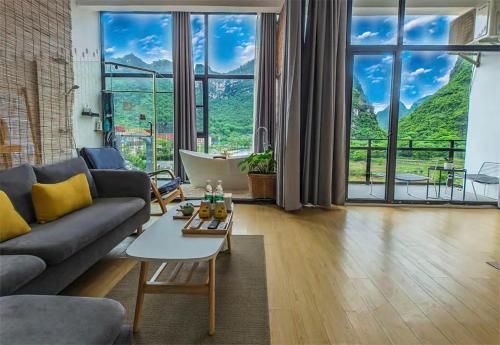 a living room with a couch and a table at Sure I Do全景山宿 in Yangshuo