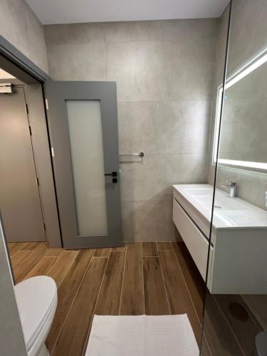 a bathroom with a toilet and a sink and a shower at City Stay B&B in Taʼ l-Imgħajjen