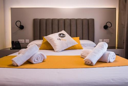 a bed with three rolled towels on top of it at City Stay B&B in Taʼ l-Imgħajjen