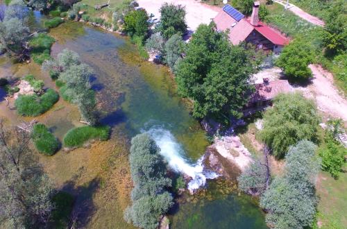 an aerial view of a river next to a house at Rooms S&I Korana in Slunj
