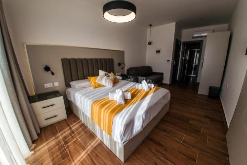 a bedroom with a large bed with towels on it at City Stay B&B in Taʼ l-Imgħajjen