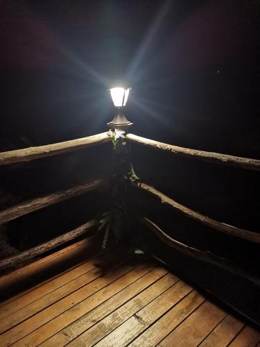 a light in a dark room with a wooden floor at Rooms S&I Korana in Slunj