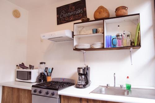 a kitchen with a sink and a stove top oven at Casa San Cristóbal in San Cristóbal de Las Casas