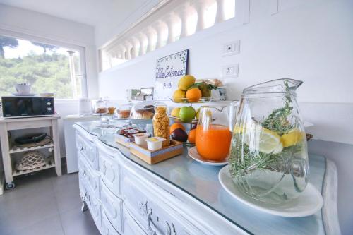a kitchen with a counter with a vase filled with fruit at Villa Costanza sorrento B&b in Sant'Agnello