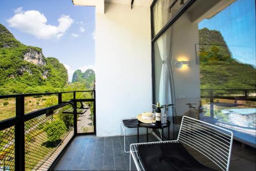 a balcony with a view of the mountains at Sure I Do全景山宿 in Yangshuo
