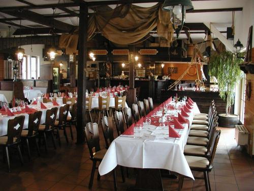 a dining room with tables and chairs with red napkins at Ankerhof Hotel in Halle an der Saale