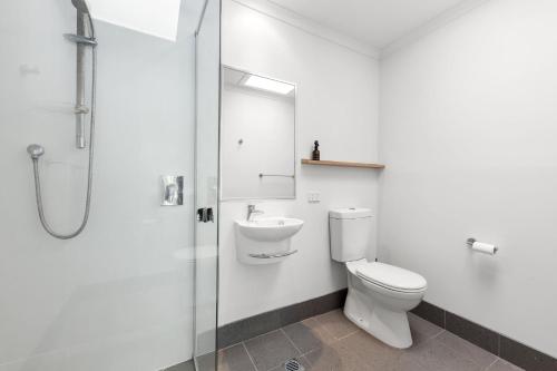 a bathroom with a toilet and a sink and a shower at 5 Samarin Court Convenient and Comfortable in Sunshine Beach