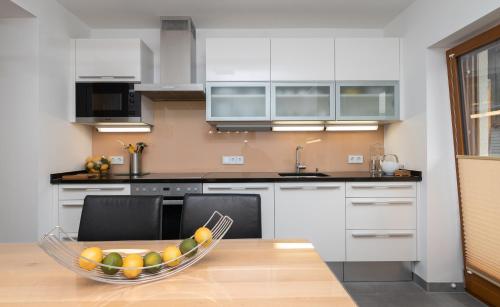 a kitchen with a bowl of fruit on a table at Lake View Apartment in St. Wolfgang