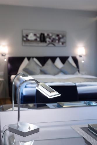 a hotel room with a bed and a table with a lamp at Lake View Apartment in St. Wolfgang