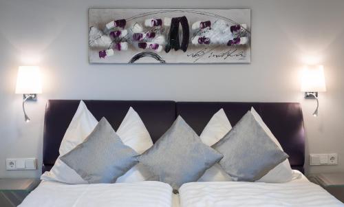 a bedroom with a bed with blue and white pillows at Lake View Apartment in St. Wolfgang