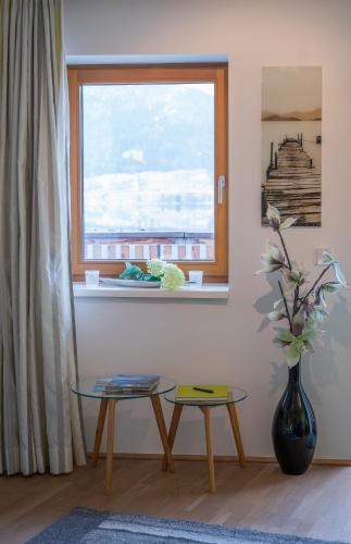 a living room with a table and a window at Lake View Apartment in St. Wolfgang