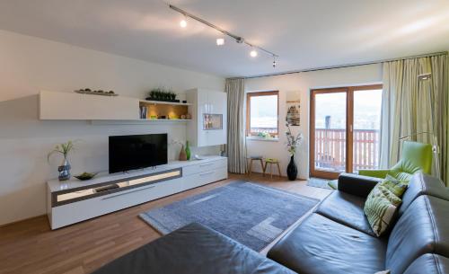 a living room with a couch and a tv at Lake View Apartment in St. Wolfgang