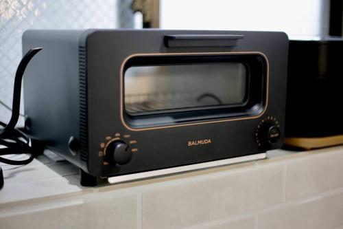 a black toaster oven sitting on top of a counter at Pufuka Inn Skytree in Tokyo