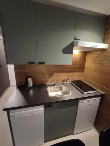 a kitchen with a sink and a counter top at Carol Rooms in Trogir
