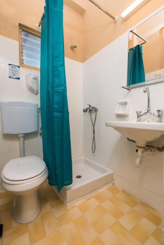 a bathroom with a toilet and a sink at Southgate Apartments in Agios Georgios