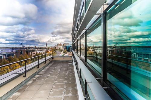 a balcony of a building with a view of the city at Prize by Radisson, Rostock City in Rostock