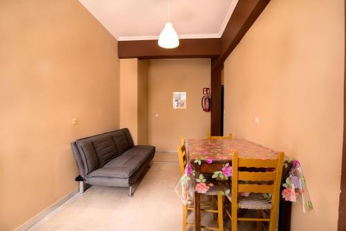 a dining room with a table and a chair at Southgate Apartments in Agios Georgios