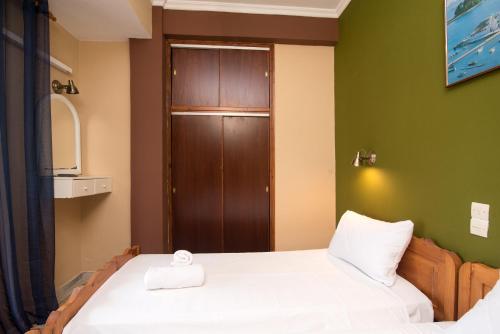 a small room with two beds and a door at Southgate Apartments in Agios Georgios