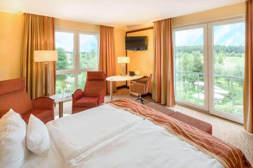En eller flere senge i et værelse på Best Western Premier Castanea Resort Hotel