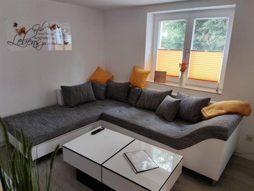 a living room with a couch and a coffee table at Allgäuerferienwohnung in Sulzberg