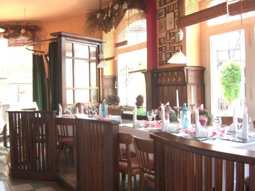 a dining room with a long table and chairs at Hotel Werratal in Bad Sooden-Allendorf