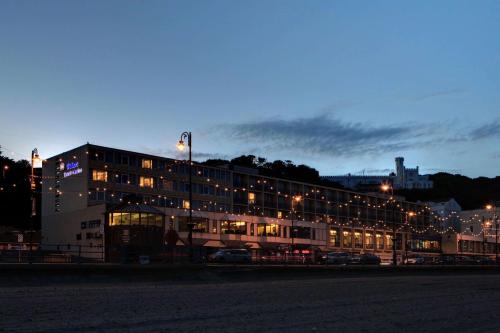 a building at night with cars parked in front of it at Best Western Palace Hotel & Casino in Douglas