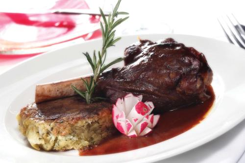 a plate with a piece of meat with sauce and gravy at Best Western Palace Hotel & Casino in Douglas