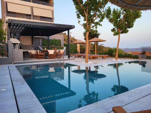 a swimming pool in front of a house at ''Stergiou Luxury Apartment 2nd Floor'' με κοινη πισινα in Saronida