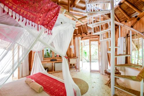 a bedroom with a hammock in a tree house at Le Bamboo Bali in Uluwatu